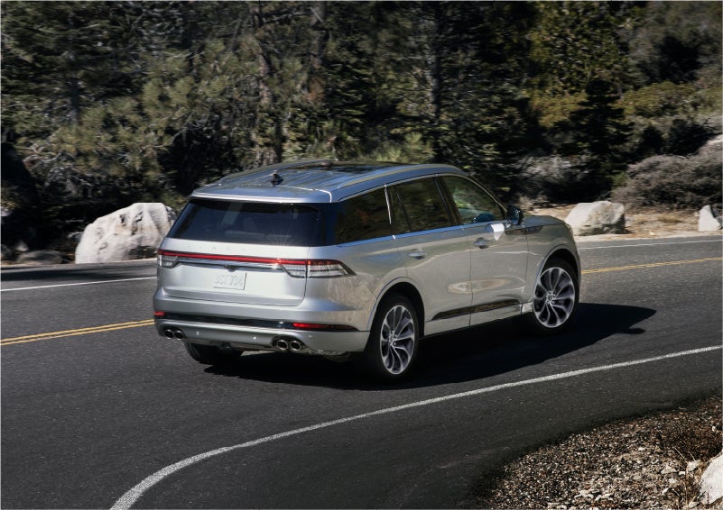 A 2023 Lincoln Aviator® Grand Touring model is shown being driven on a tight turn of a mountain road | Pugmire Lincoln of Marietta in Marietta GA