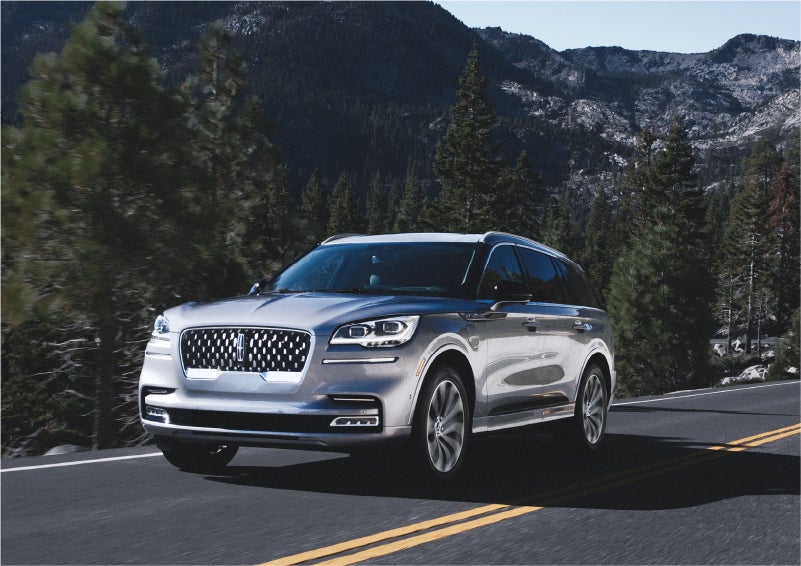A 2023 Lincoln Aviator® Grand Touring SUV being driven on a winding road to demonstrate the capabilities of all-wheel drive | Pugmire Lincoln of Marietta in Marietta GA