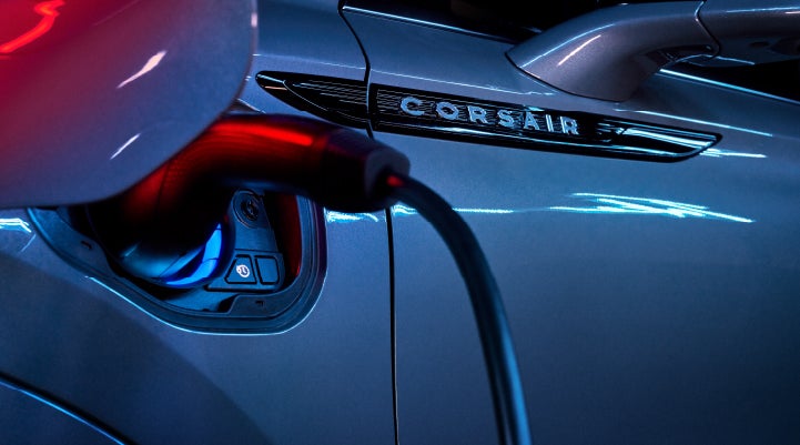 A charger plugged into the charging port of a 2024 Lincoln Corsair® Plug-in Hybrid model. | Pugmire Lincoln of Marietta in Marietta GA